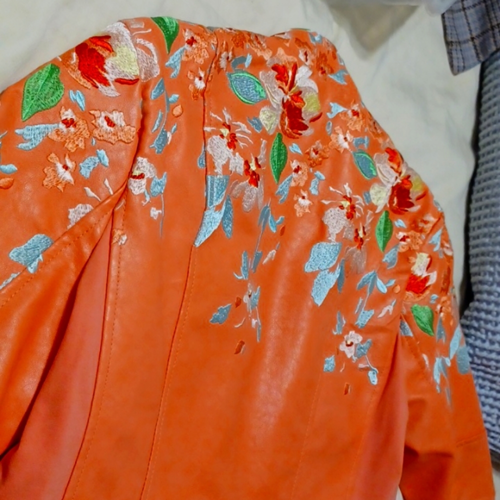 Coral faux leather jacket with embroidered turquoise, gold zipper at wrists